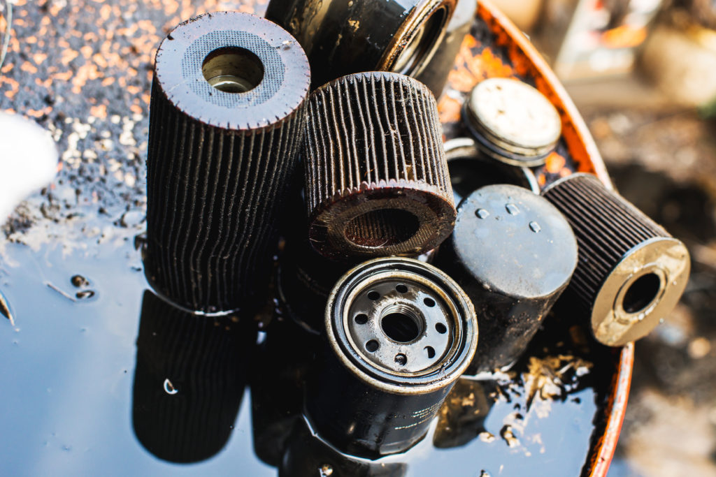 Used oil purification filters on the dirty surface of the barrel with a shallow depth of field